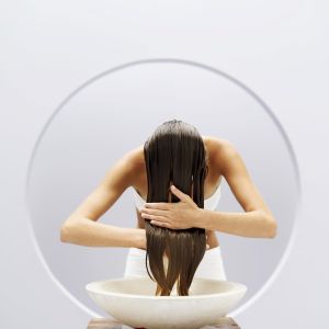 woman washing her hair in a basin