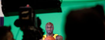 Lamar Odom, forward, for the Los Angeles Lakers, palms a basketball while being videotaped during L