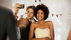 Couple taking a selfie at prom party