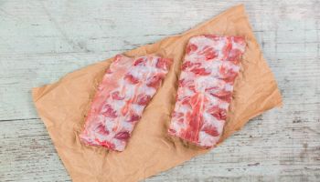Raw spare ribs on brown paper