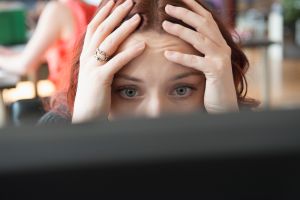 Frustrated Caucasian businesswoman using computer