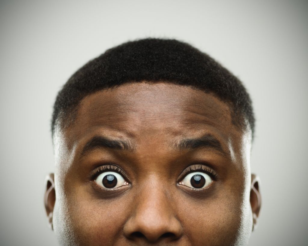 Close-up portrait of african man shocked