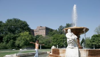 A girl walking on the classical fountain near Museum of Art.