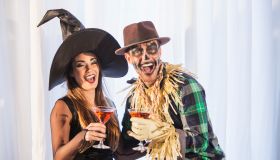 Witch and scarecrow at adult halloween party