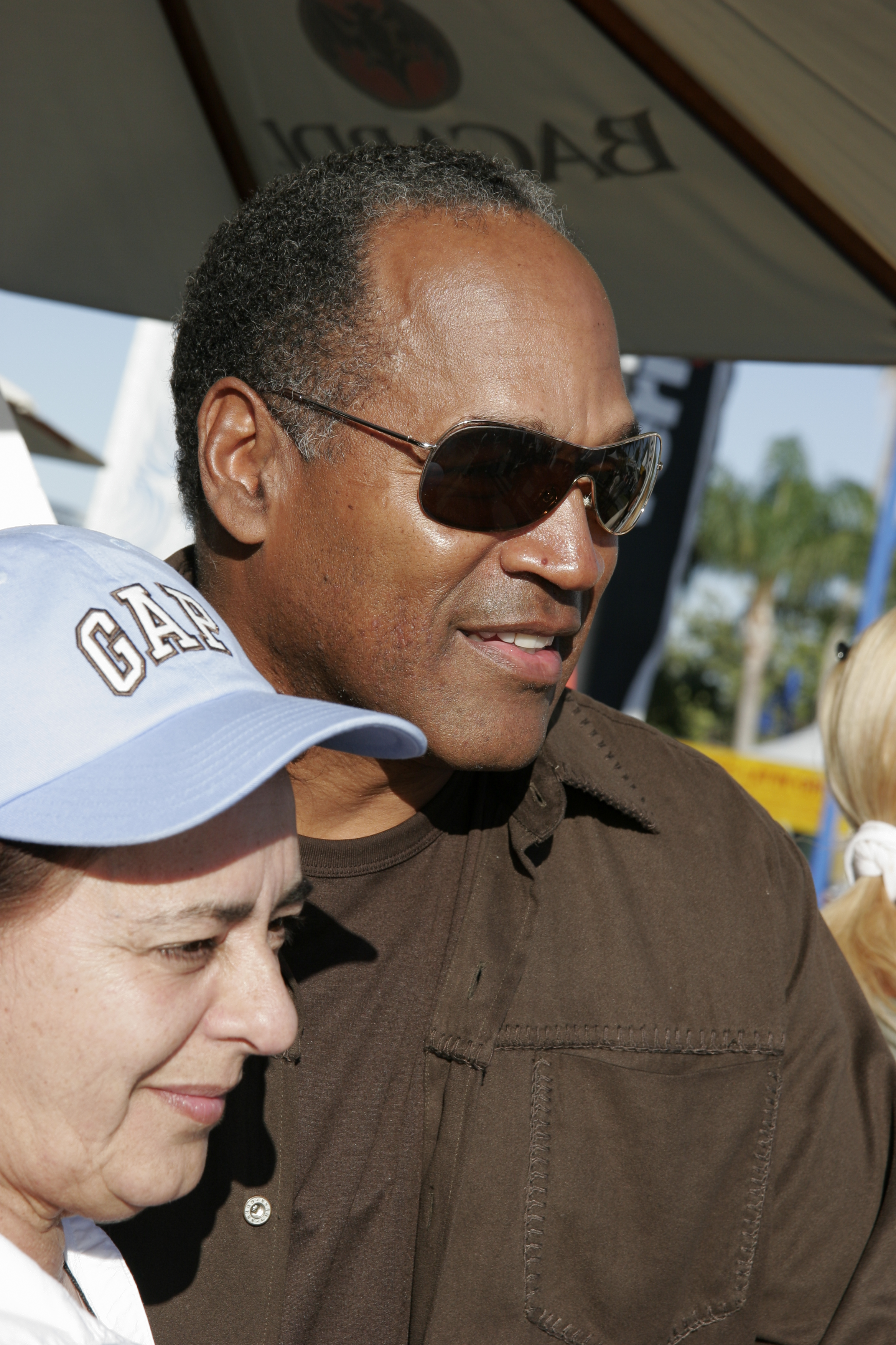 OJ Simpson posing for a photo with a woman at the Arts Festival