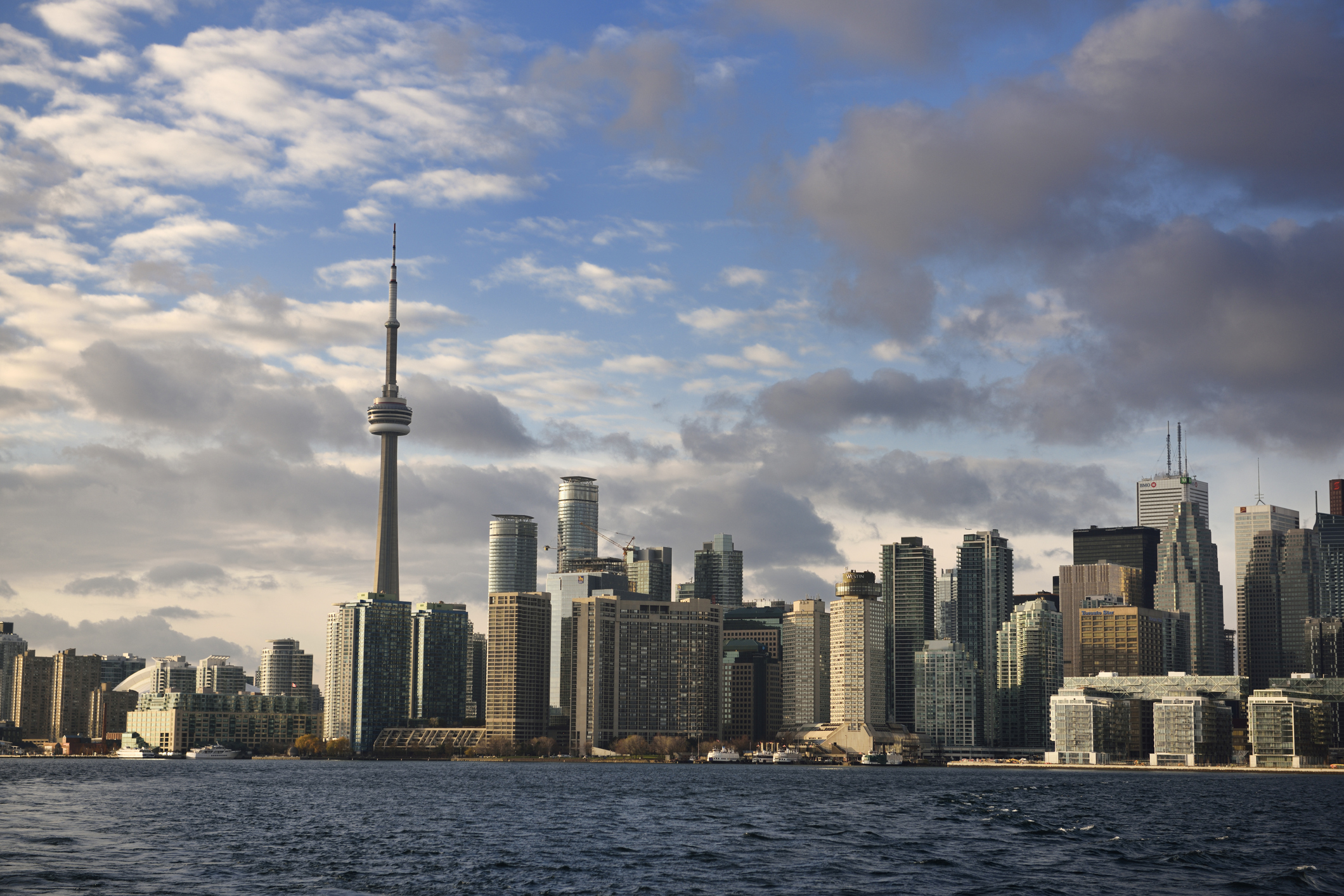 Evening sunlight on Toronto skyline high rise towers from Ferry in harbor