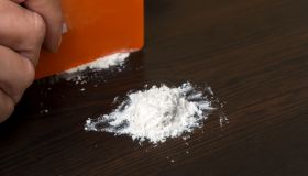 Cropped Hand Having Cocaine With Credit Card On Table