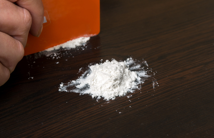 Cropped Hand Having Cocaine With Credit Card On Table