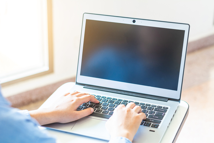 Cropped Image Of Man Using Laptop