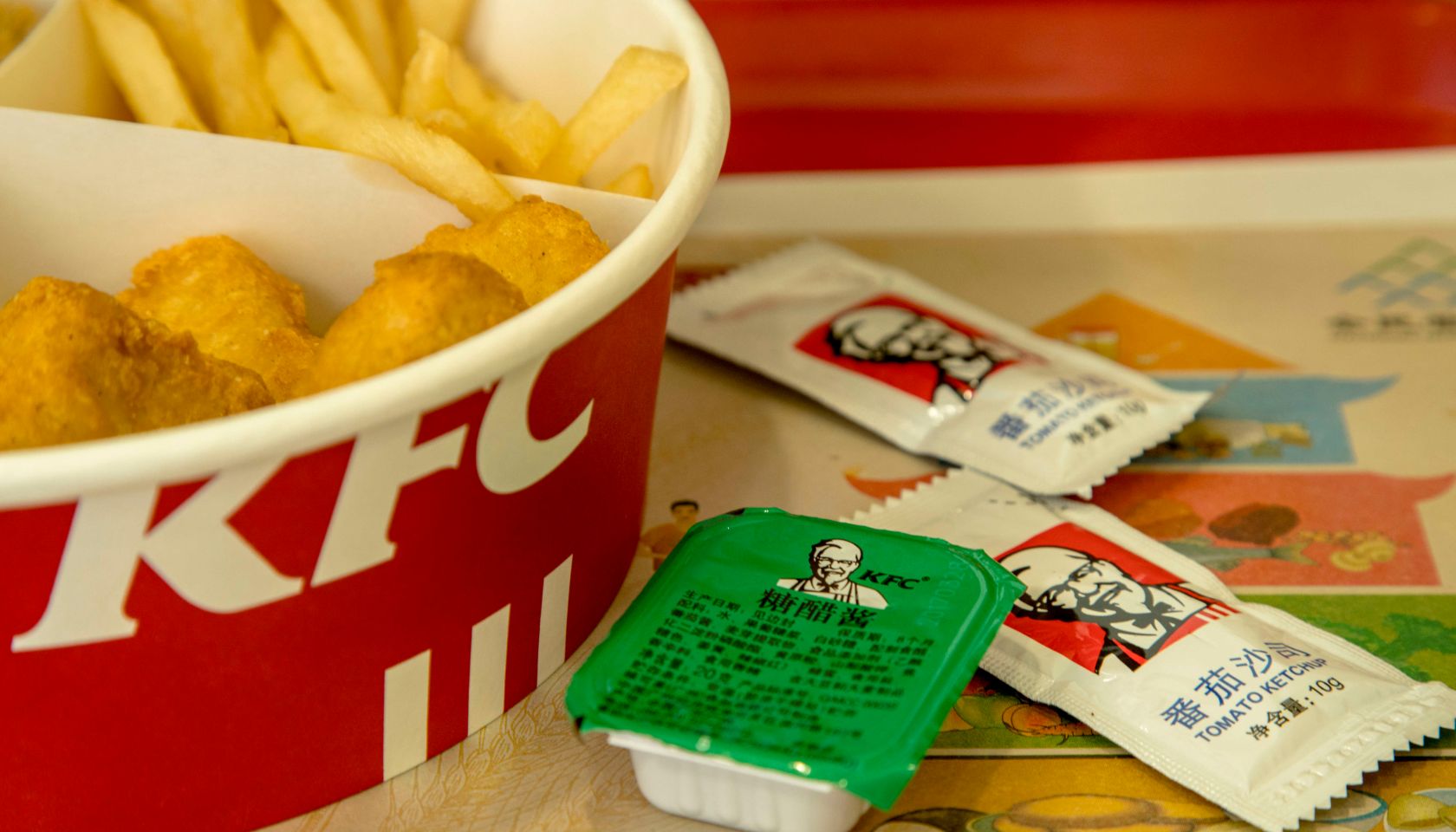 KFC food box filled with fried chicken and chips. Since...