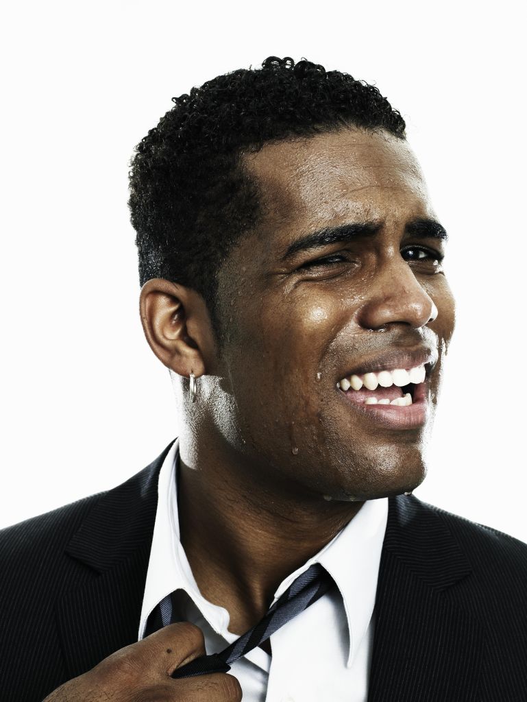 Businessman sweating, pulling at tie, close-up