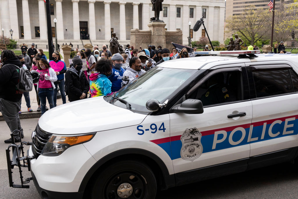 Columbus Police cruisers round the Ohio Statehouse interact...