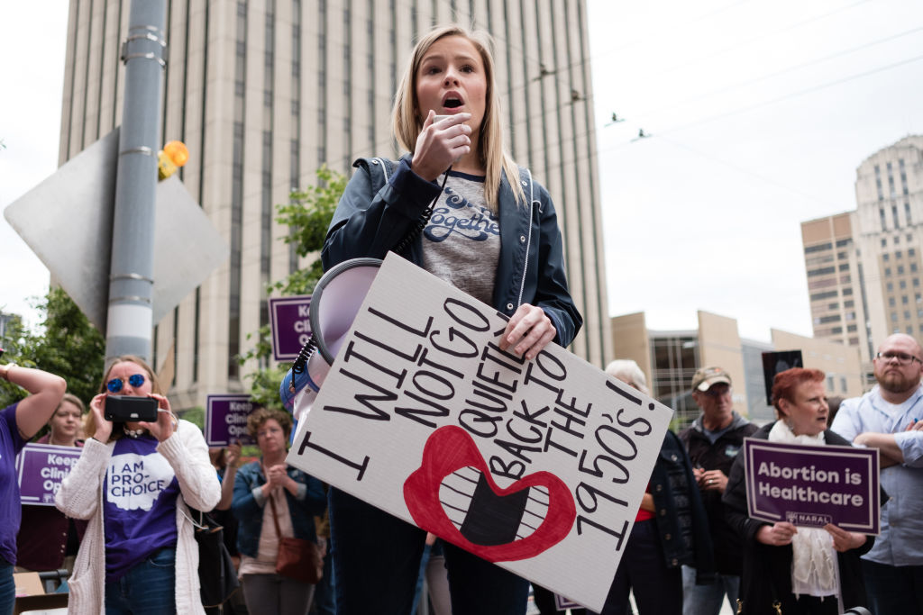 An activist seen chanting slogans on a megaphone while...