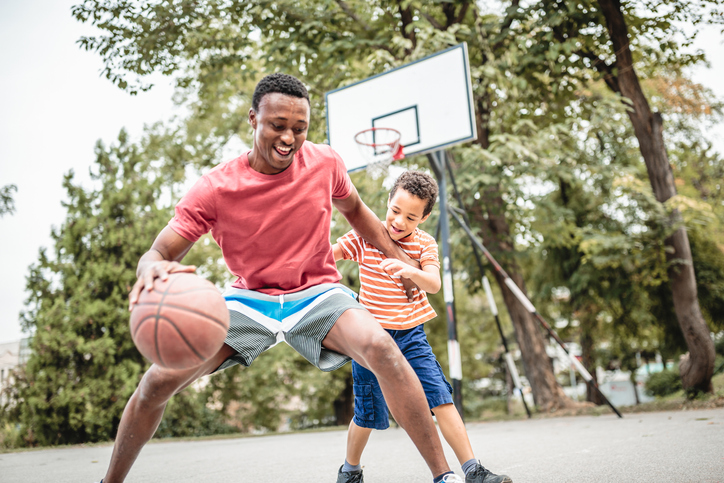 Father and son playing basketball