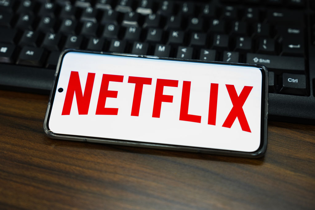 In this photo illustration, a Netflix logo is displayed on...