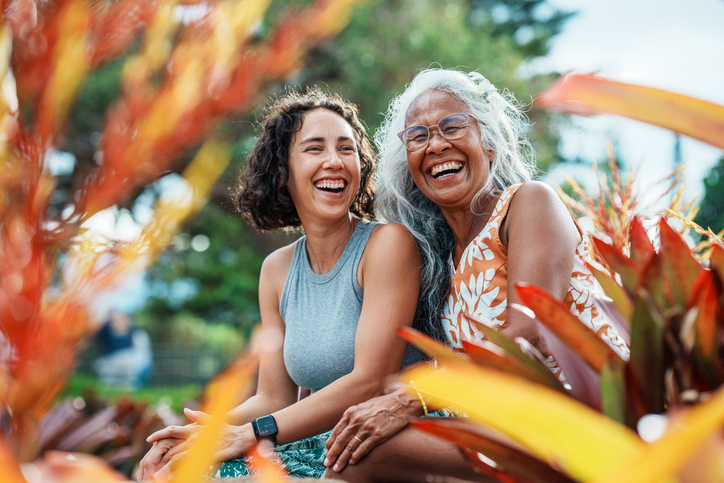 Pacific Islander woman and Eurasian adult daughter spending time together outdoors