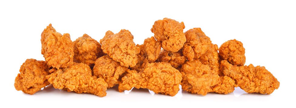 Heap of fried spicy chicken wings isolated on white