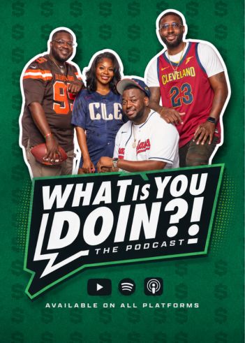 Four people posing together, including a man wearing a Cleveland jersey with the number 23 and a woman wearing a shirt with "CLB" on it.