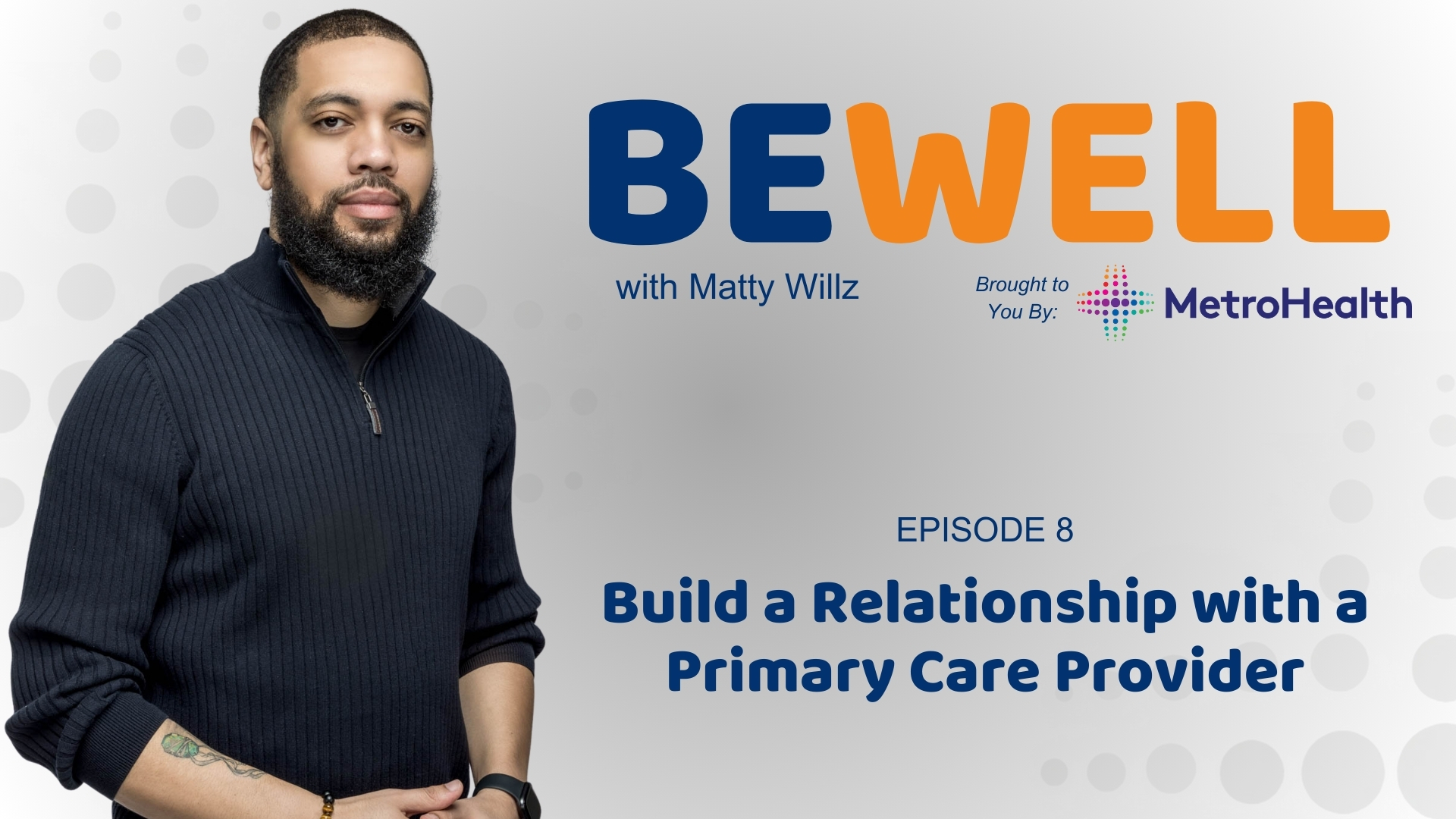 A man with a beard wearing a black sweater stands in front of a wall with the "Be Well with Matty Willz" logo and the MetroHealth logo.